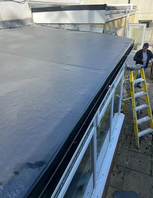 EPDM flat roof edge trim and new guttering being installed