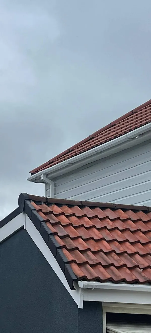 Close-up of newly fitted clay ridge and roof tiles